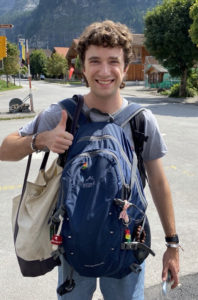 A thumbs up on a mountain road, pack on my back