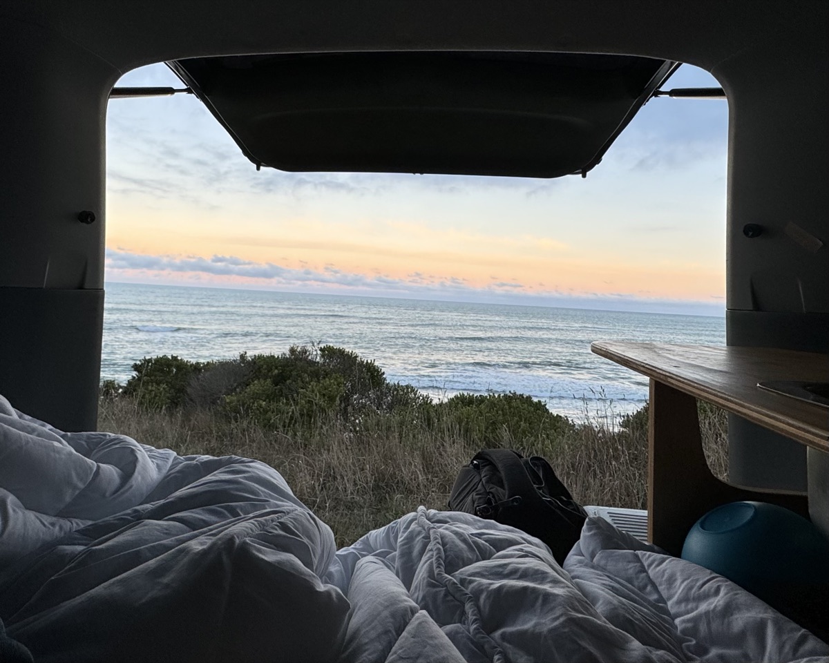 The sea at dusk, seen from the back of a van