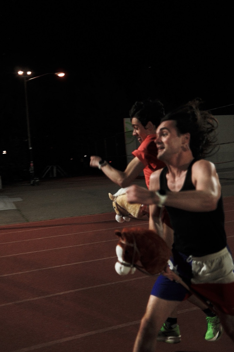 A hobby-horse race on a floodlit track at night