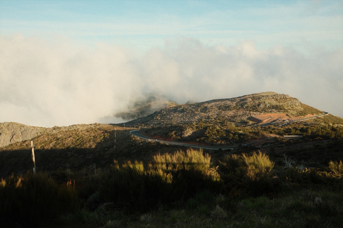 Clouds breaking over a mountain ridge in late light